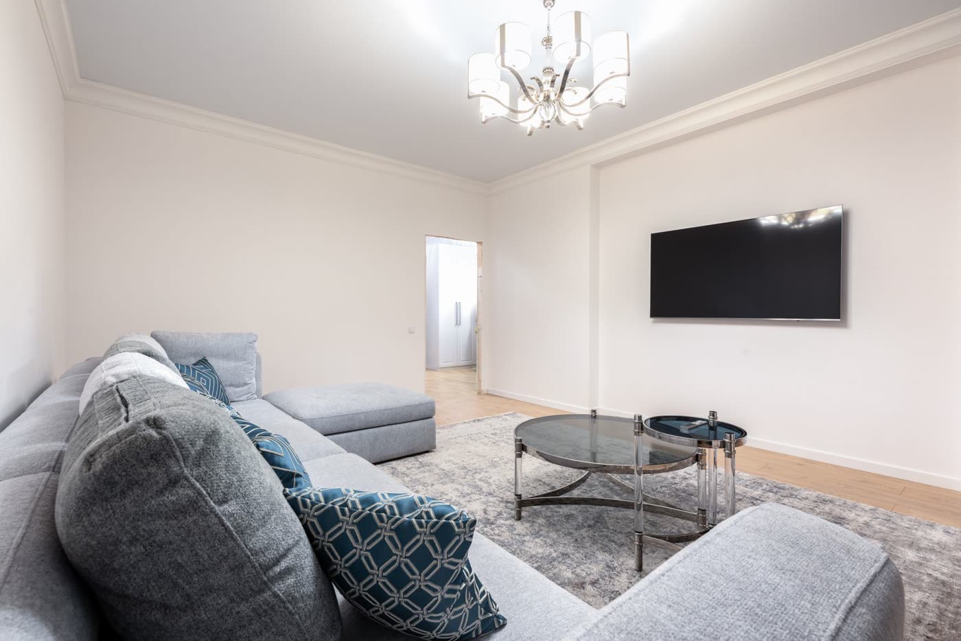 A wall-mounted TV in a clean living room